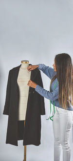 Rear view of woman standing against sky