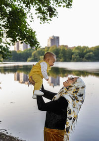 Happy mother carrying baby daughter