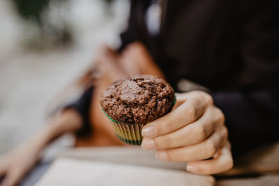 Close-up of hand holding muffin