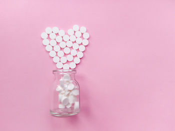 Close-up of heart shape made from glass on table