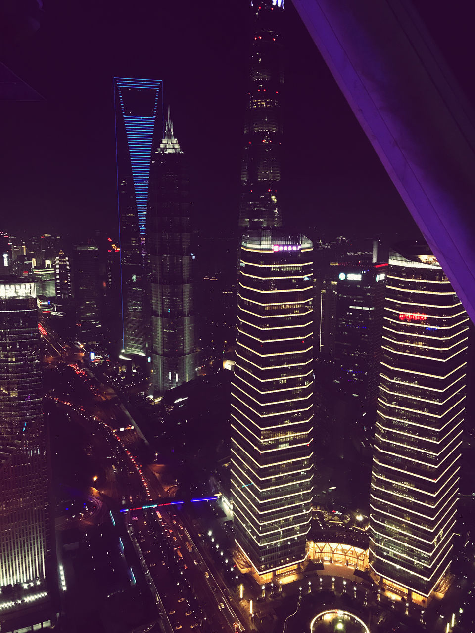 ILLUMINATED MODERN BUILDINGS IN CITY AT NIGHT