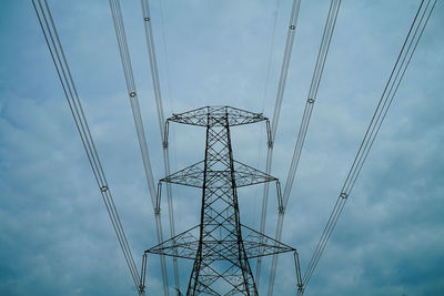 Low angle view of electricity pylon against sky