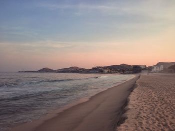 Scenic view of beach against sky during sunset