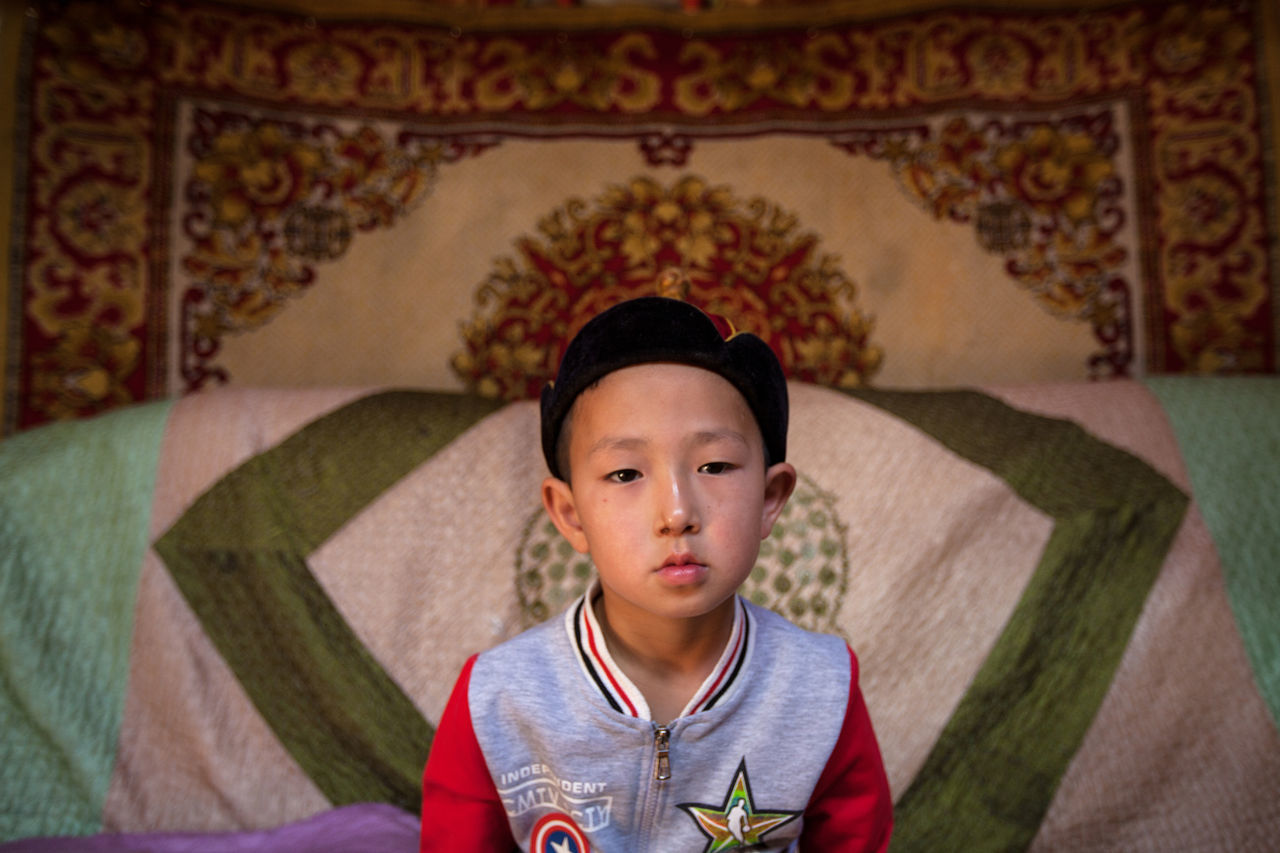 child, childhood, one person, boys, front view, portrait, males, real people, lifestyles, men, leisure activity, casual clothing, looking at camera, architecture, headshot, looking, indoors, innocence, contemplation