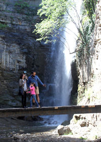 People enjoying in river against trees