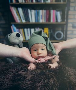 Portrait of baby and parent hands