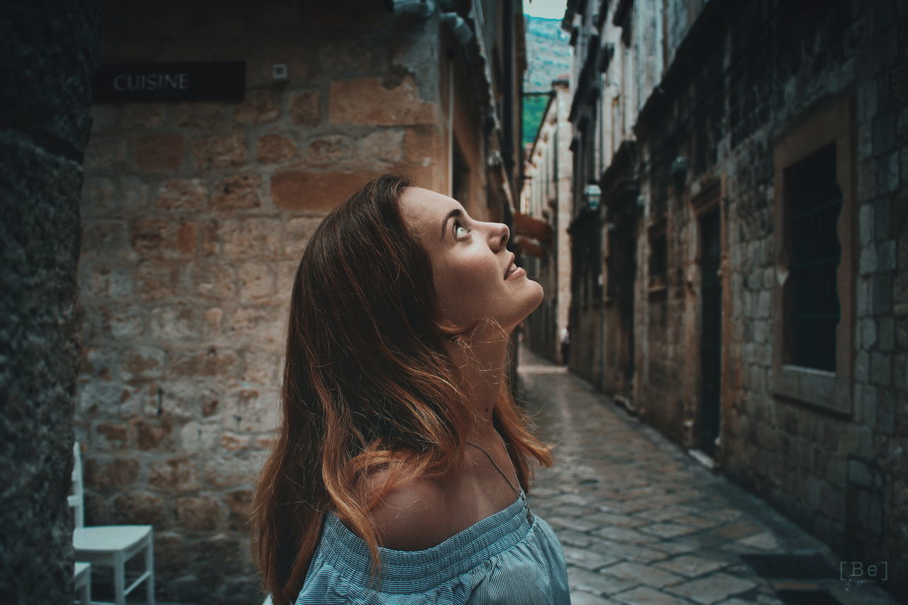 Look up Girl Beautiful Woman VSCO Castle EyeEmNewHere City Portrait Beautiful Woman Young Women Beauty Head Back Side View Street Art Brick Wall Brick Building Wall - Building Feature This Is Natural Beauty