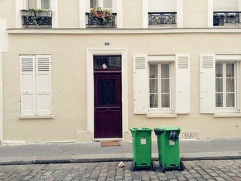 Garbage cans against building