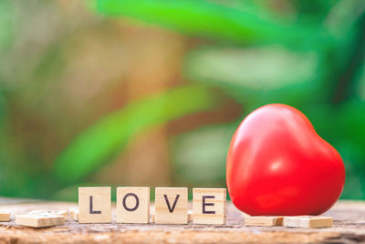 Close-up of heart shape with love text on table