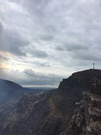 Scenic view of mountain against cloudy sky