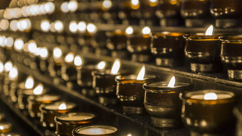 Candles burning in row