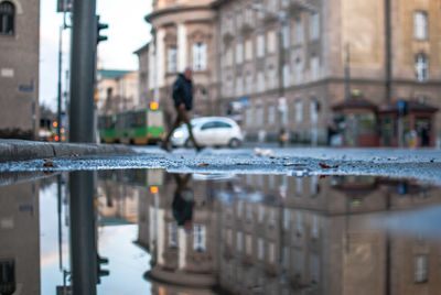 Reflection of buildings in puddle