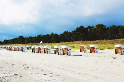 Scenic view of beach against cloudy sky