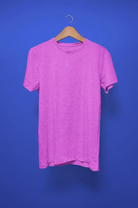 Close-up of pink bell hanging against blue background