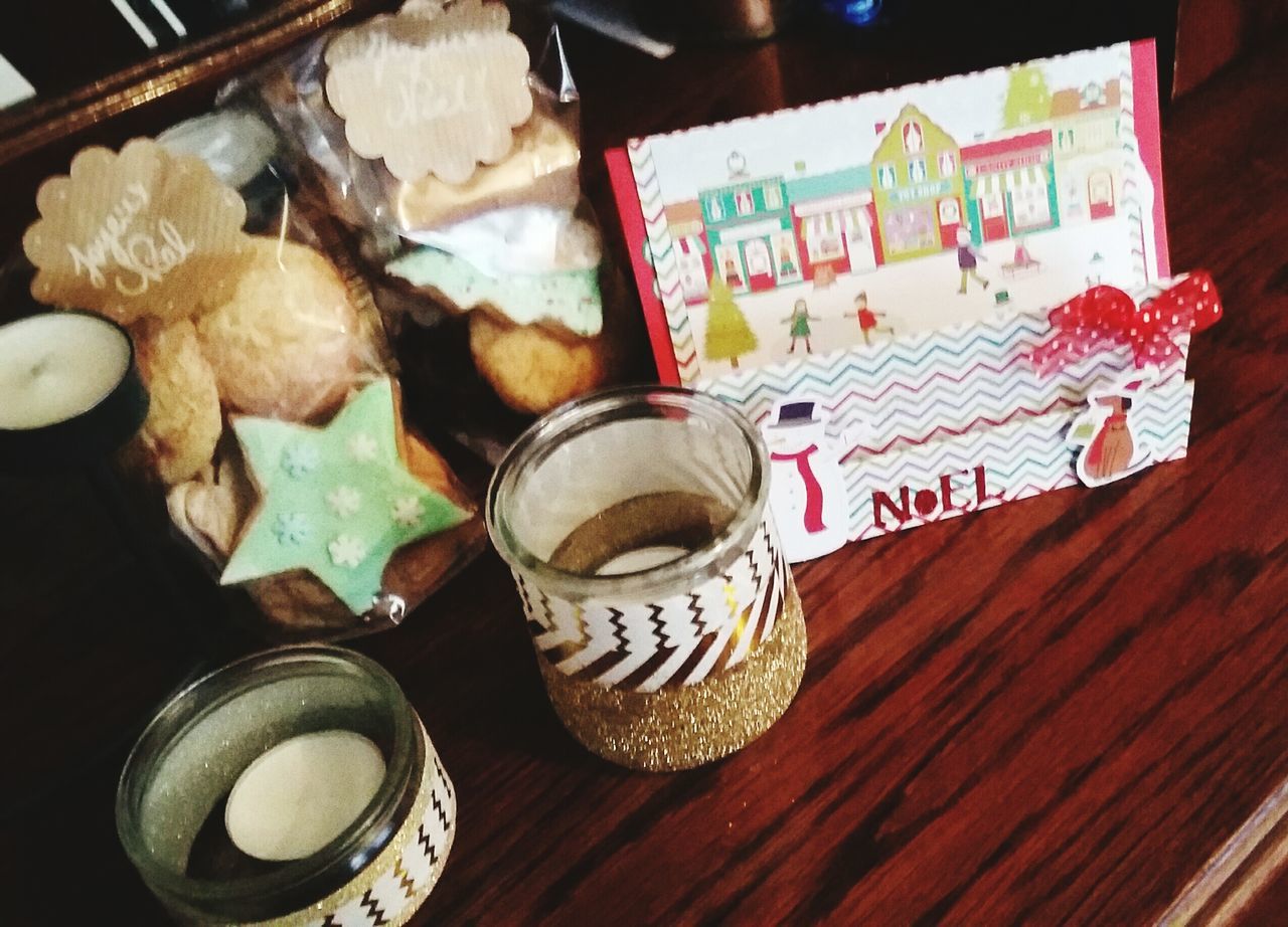 indoors, food and drink, table, drink, freshness, still life, refreshment, high angle view, coffee cup, coffee - drink, wood - material, food, text, sweet food, no people, saucer, cup, close-up, communication, coffee