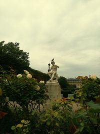 Statue against trees and sky