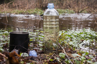 Water bottle on table by lake