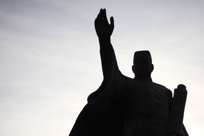 Low angle view of statue against sky