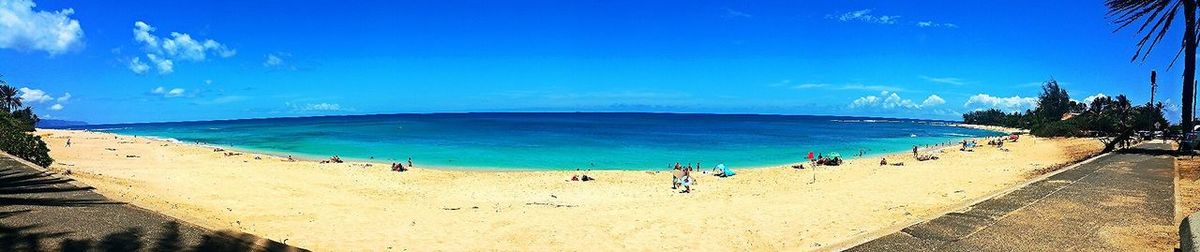 Scenic view of beach against blue sky