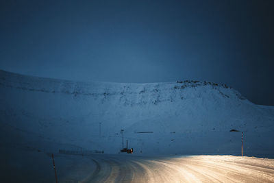 Low section of man standing on snow