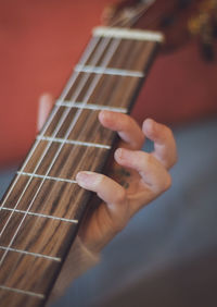 Little girl plays the guitar.