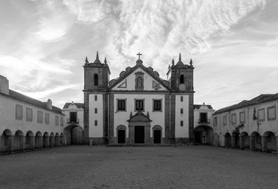 Facade of church against cloudy sky