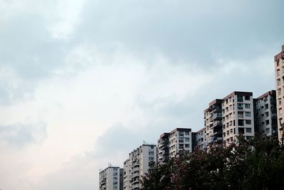 Low angle view of building against cloudy sky