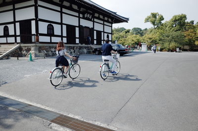 People riding bicycle on road