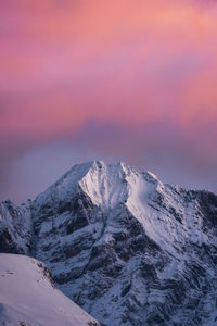 Scenic view of snowcapped mountains against sky during sunset