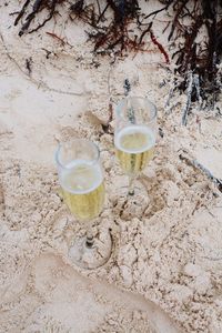 High angle view of wine glasses on beach