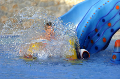 Girl swimming in pool at water park