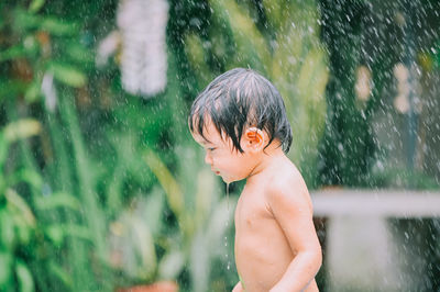 Cute girl playing amidst splashing water