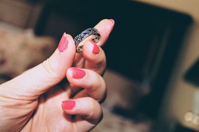 Close-up of hand holding lizard