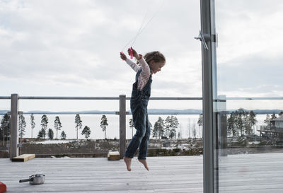 Girl skipping on her balcony at home over looking the sea