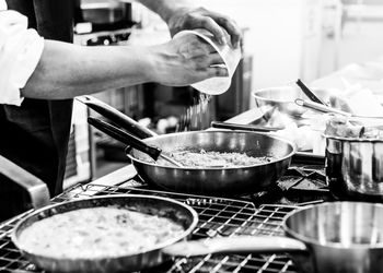 Midsection of man preparing food in kitchen