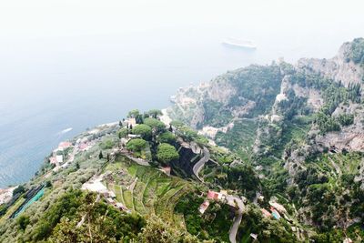 High angle view of townscape by sea against sky