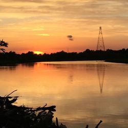 Scenic view of lake against sky at sunset