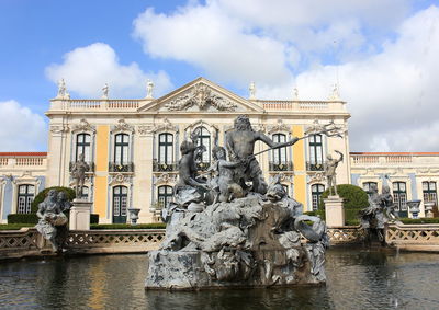 Low angle view of fountain in city against sky