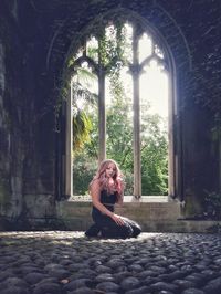 Full length of woman sitting at park