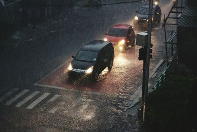 High angle view of vehicles on street during rainfall