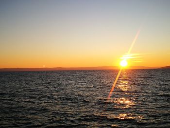 Scenic view of sea against clear sky during sunset