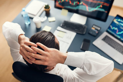 Worried businessman looking at charts stressed by news from stock market. investor lost money online