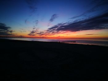 Scenic view of beach against sky during sunset