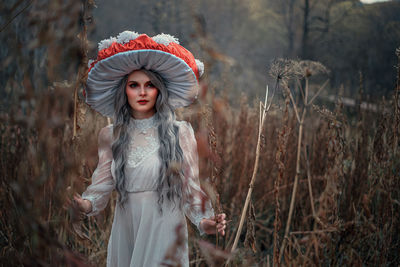 Portrait of woman standing in forest