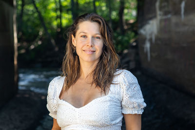 Portrait of smiling young woman standing outdoors