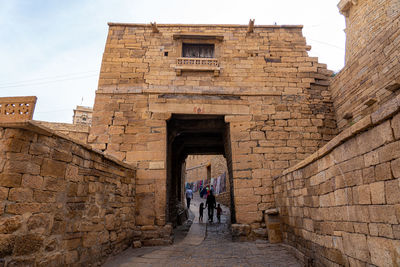 People walking in front of historical building