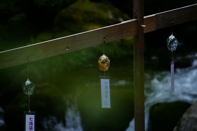 Close-up of lantern hanging on wood