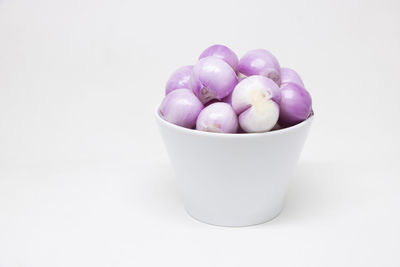 Close-up of blueberries in bowl against white background