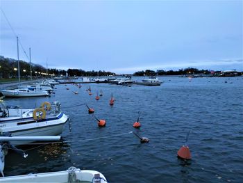 High angle view of sailboats moored in sea against sky