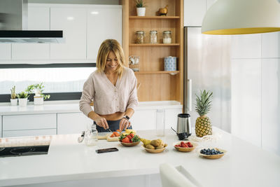 Midsection of woman preparing food at home